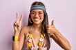 © Krakenimages.com - Beautiful hispanic woman wearing bohemian and hippie style doing peace symbol smiling happy and positive, thumb up doing excellent and approval sign