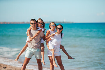 Happy family on the beach during summer vacation