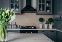 Vase Of White Tulips In A Modern Kitchen. Home Concept With Spring Flowers.