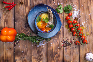 Wall Mural - Soup in the assortment, tomatoes, spices on a brown wooden background.