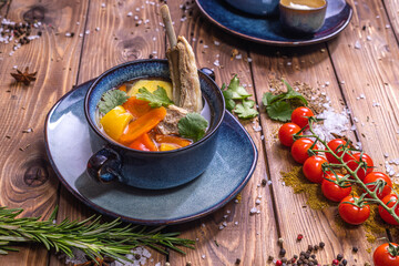 Wall Mural - Soup in the assortment, tomatoes, spices on a brown wooden background.