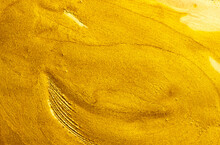 Beautiful Abstract Golden Liquid Paint Background, Beauty Gold Backdrop Texture. Metallic Gold Paint, Art Design. Yellow Shimmering Surface Close-up. Golden Bright Glitter Texture, Macro Shot 