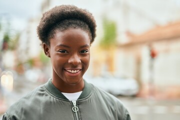 Poster - Young african american girl smiling happy standing at the city.