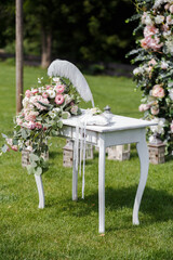 Wedding table for painting decorated with natural pink and white flowers. Wedding decoration concept