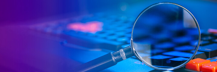 magnifying lens on the laptop keyboard in blue light