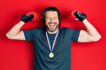 Canvas Print - Middle age caucasian man wearing first place medal on boxing competition smiling and laughing hard out loud because funny crazy joke.