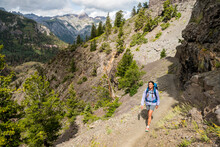 A Woman Hiking Along The Bear Creek National Recreation Trail, Uncompahgre National Forest, Ouray, Colorado.