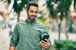 © Krakenimages.com - Young hispanic man smiling happy using smartphone at the city.