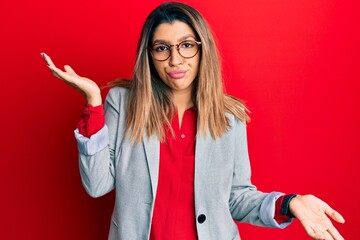 Poster - Beautiful brunette woman wearing business shirt and glasses clueless and confused with open arms, no idea and doubtful face.