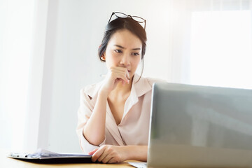 new normal, a businesswoman uses a computer to work for a company Via the internet on your desk at home