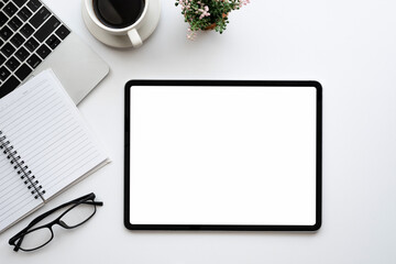 Mock up. Digital tablet blank white screen placed at table with coffee and in the office.