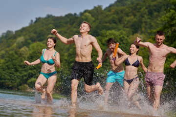 group of happy friends having fun on river