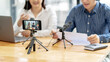 © mojo_cp - Attractive asian people vlogger content creator online live talking together sharing marketing project, Podcast creation. .