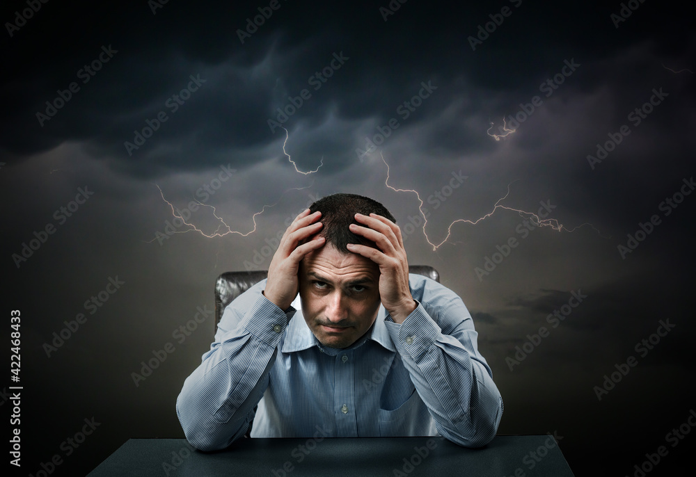 Depressed businessman under heavy clouds - obrazy, fototapety, plakaty 