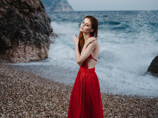 Woman in red dress sea waves beach landscape