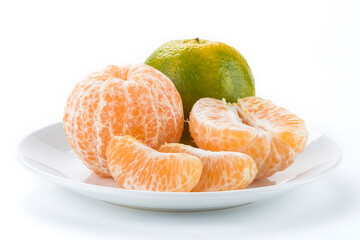 Close-up peeled oranges isolated on a white dish