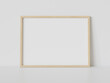 Wooden frame leaning on white floor in interior mockup. Template of a picture framed on a wall 3D rendering