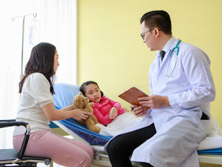 Mother caring of daughter during visit to doctor