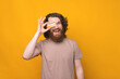 © Vulp - Young bearded hipster man with long curly hair showing credit card