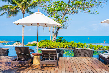 Wall Mural - Umbrella and chair around outdoor swimming pool in hotel resort