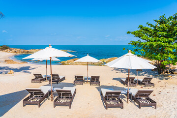 Wall Mural - Beautiful tropical beach sea with umbrella and chair around white cloud and blue sky