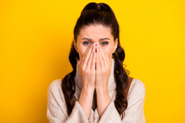 Poster - Close-up portrait of attractive worried nervous girl closing face crying suffering isolated over bright yellow color background