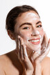 Beauty woman using cleansing foam for fresh and hydrated skincare routine, treating face from acne and blemishes, keep sebum level in balance, smiling happy at camera, white background