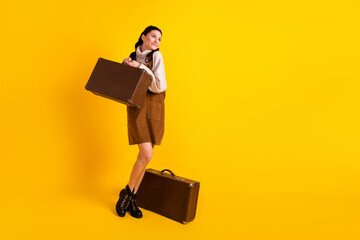 Poster - Full length body size view of attractive cheerful dreamy girl carrying bag tourism isolated over bright yellow color background