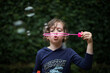 © LightItUp - Young girl blowing bubbles