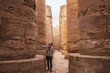 canvas print picture - Young man gazing up in wonder at the massive columns at Karnak Temple in Luxor Egypt