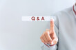 Text sign showing Q And A. Conceptual photo defined as questions being asked and answers Businessman in the blue suite with lap top pointing with finger.