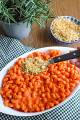 Poster - Tomato pasta Cavatappi bake in the making. Preparing oven-baked pasta with red peppers and breadcrumbs. 