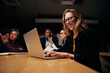 © StratfordProductions - Portrait of young successful businesswoman sitting with colleague using laptop at workplace