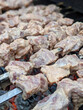 © digidreamgrafix - marinaded pork shishkabobs on charcoal grill being cooked