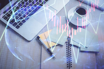 Stock market graph and top view computer on the table background. Double exposure. Concept of financial education.