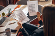 © Svitlana - Draftswoman seated at the office desk analyzing the building plans