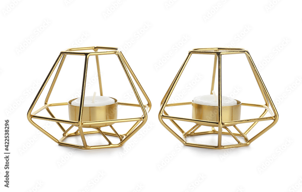 Candles in holders on white background