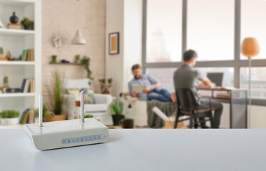 Close up modem box on the table, decorative home concept technological tool background style. Two man is spend good time.