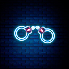 Sticker - Glowing neon line Handcuffs icon isolated on brick wall background. Colorful outline concept. Vector