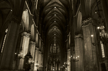 Wall Mural - Beautiful interior of Reims Notre Dame Cathedral. Evening colorful illumination, stained glass windows, statues, nave. Reims, France. Sepia photo.