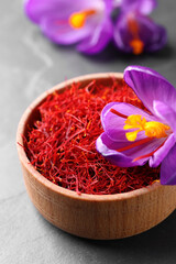 Wall Mural - Dried saffron and crocus flower on grey table, closeup