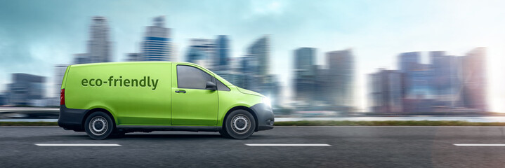 Eco-friendly van driving in front of a city skyline