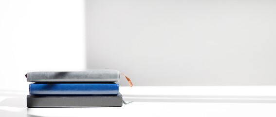 A stack of notebooks on a white background with a place for an inscription. Composition diaries for recording cases. Business composition.