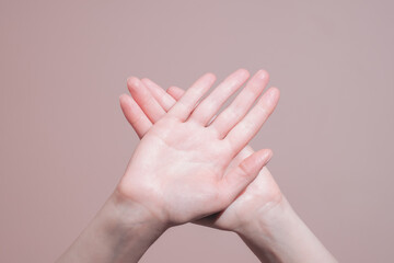 Wall Mural - Crossed female hands showing stop and no gesture, closeup. Preventing domestic violence and abuse concept