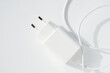 Cable plug charger on white background. Minimalistic technology concept with copy space
