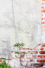 White Stucco Texture Over Aged Brick. Background With Copy Space