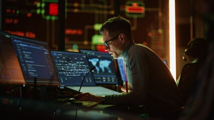 Poster - Professional IT Technical Support Specialist Making an Intercom Announcement on a Microphone and Working on Desktop Computer in Monitoring Control Room with Big Digital Screens with Server Data.