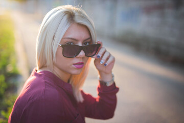 Closeup shot of a young Caucasian female posing in a sunny park