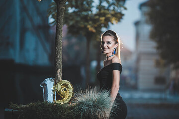 Poster - Attractive young female in an elegant black dress with 19th birthday balloons