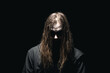 © raland - Horror person ghost creepy. Mysterious scary man with long hair. Horror scene. Black background.